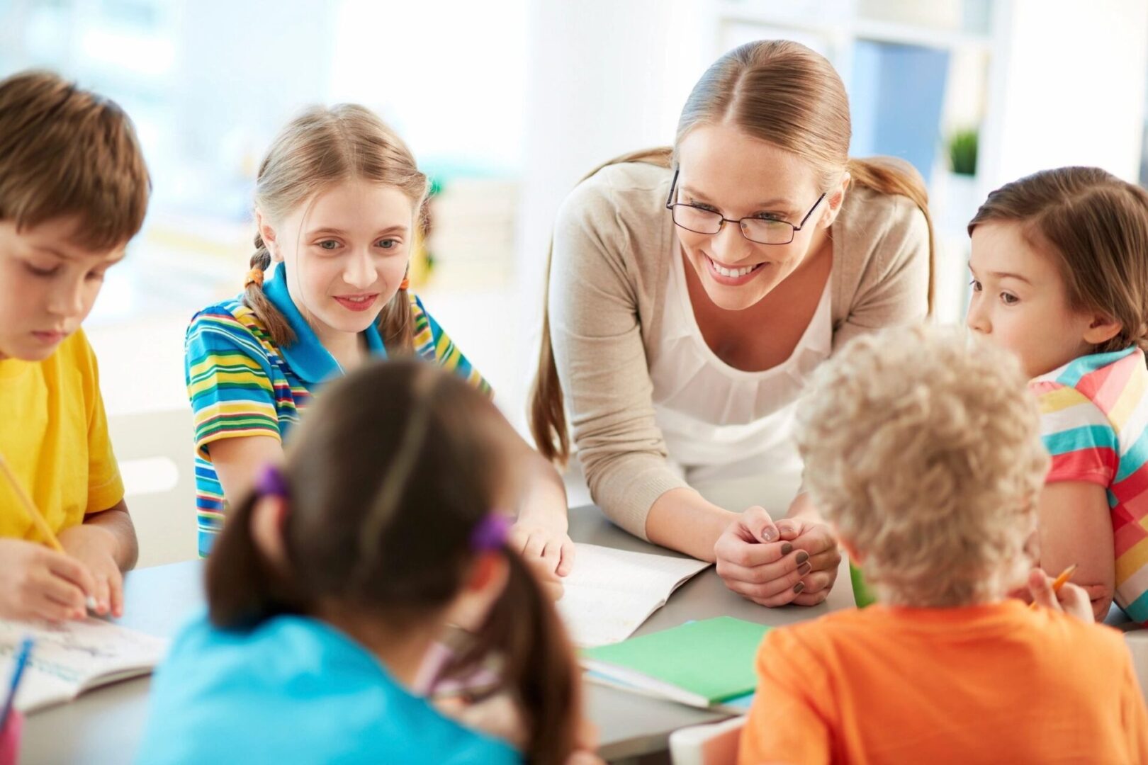 A woman and two children are sitting at the table